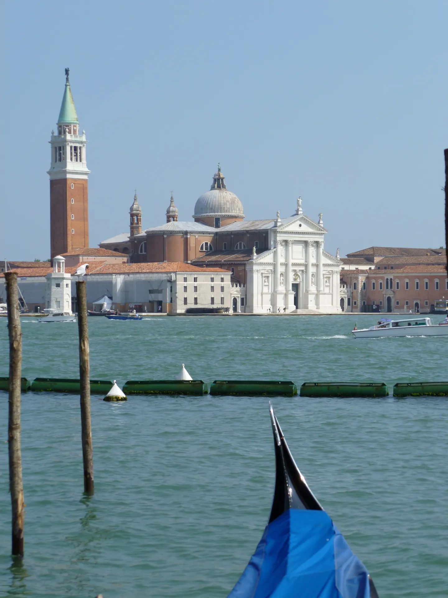 The prow of a gondola with San Giorgio Maggiore across the water behind