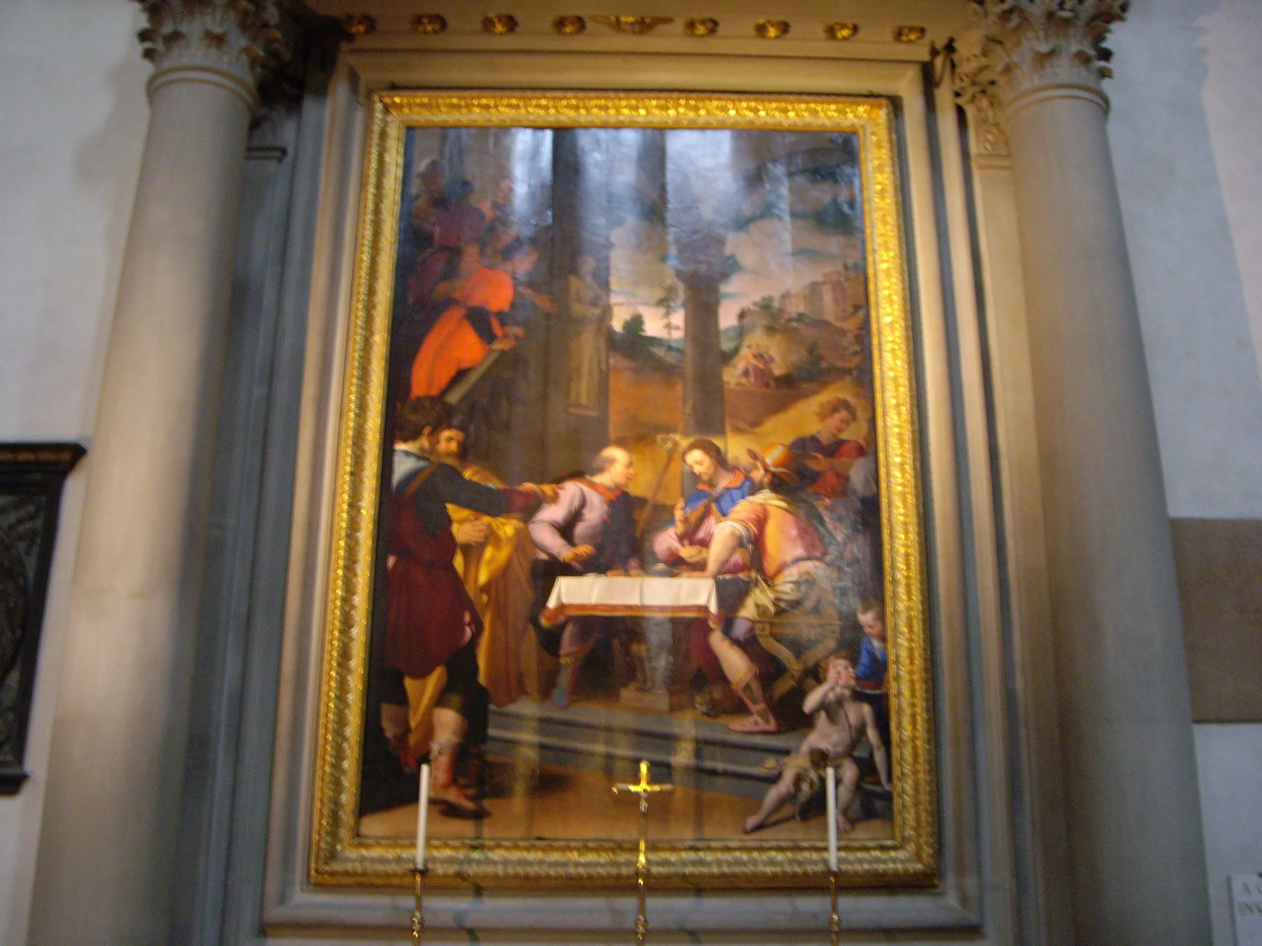 A large painting in a gilded frame on a Santa Croce altar