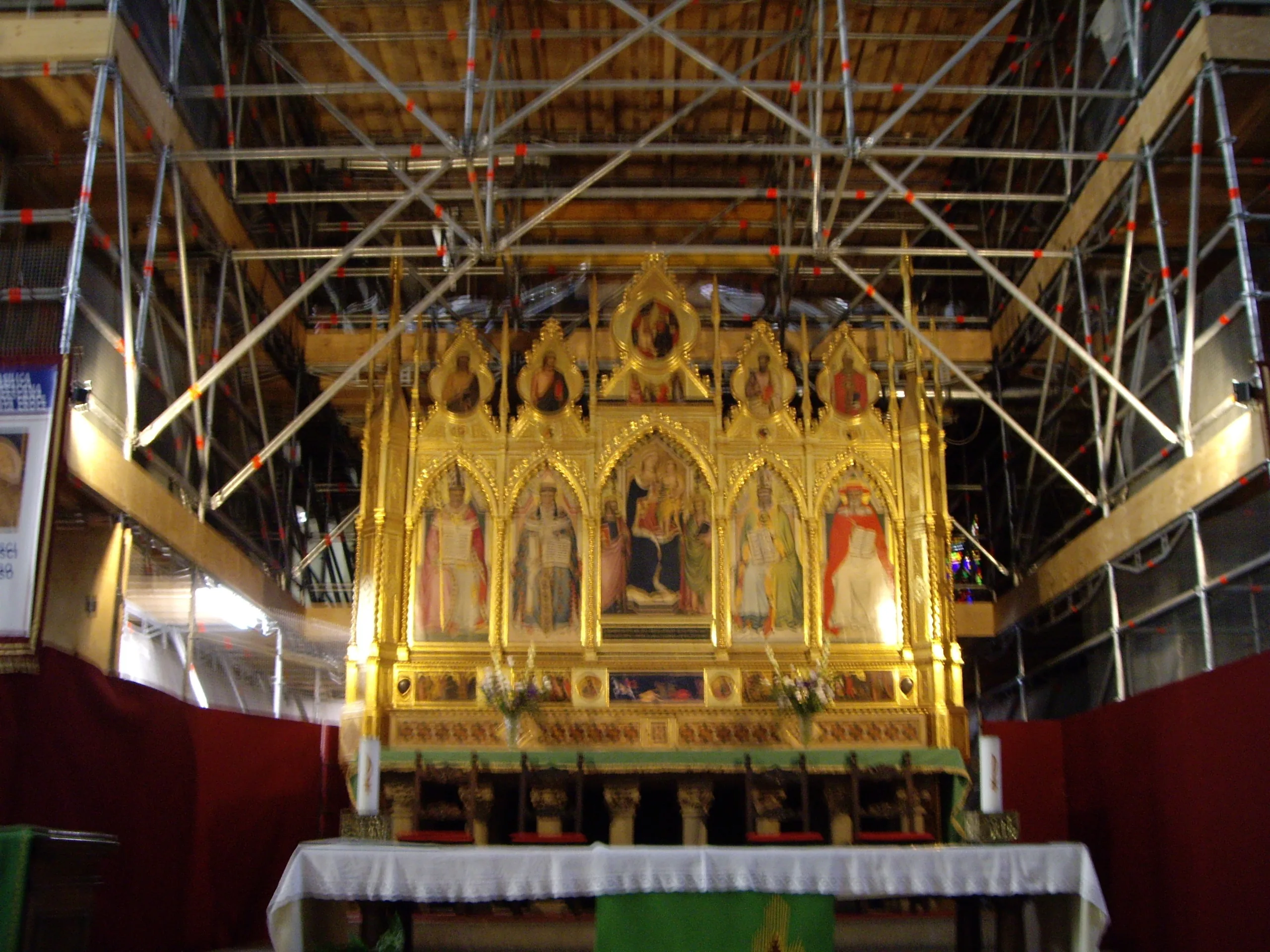 The high altar of Santa Croce with its gilded polyptych, seen under restoration scaffolding