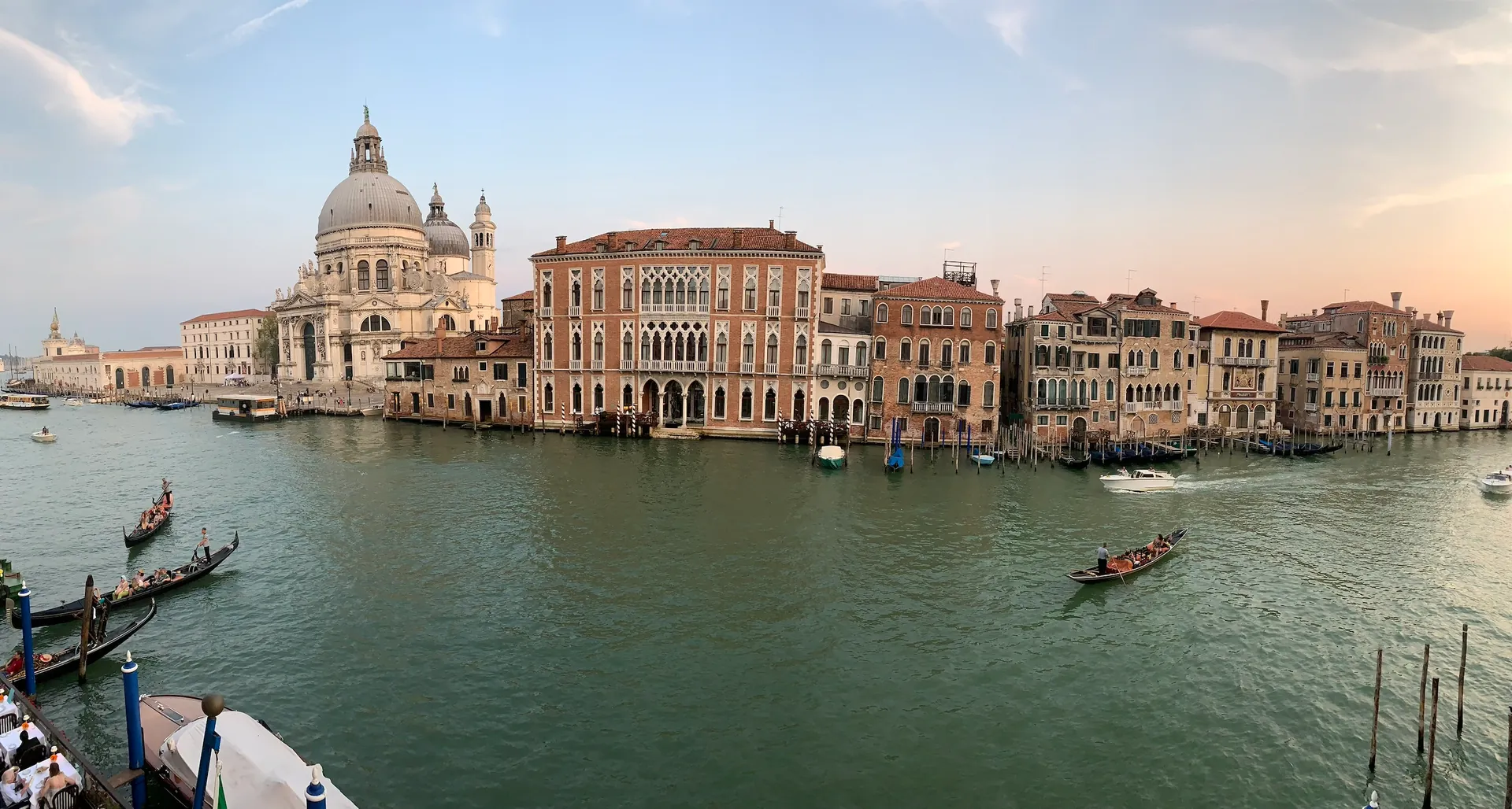 A wide golden-hour view of the Grand Canal and Santa Maria della Salute