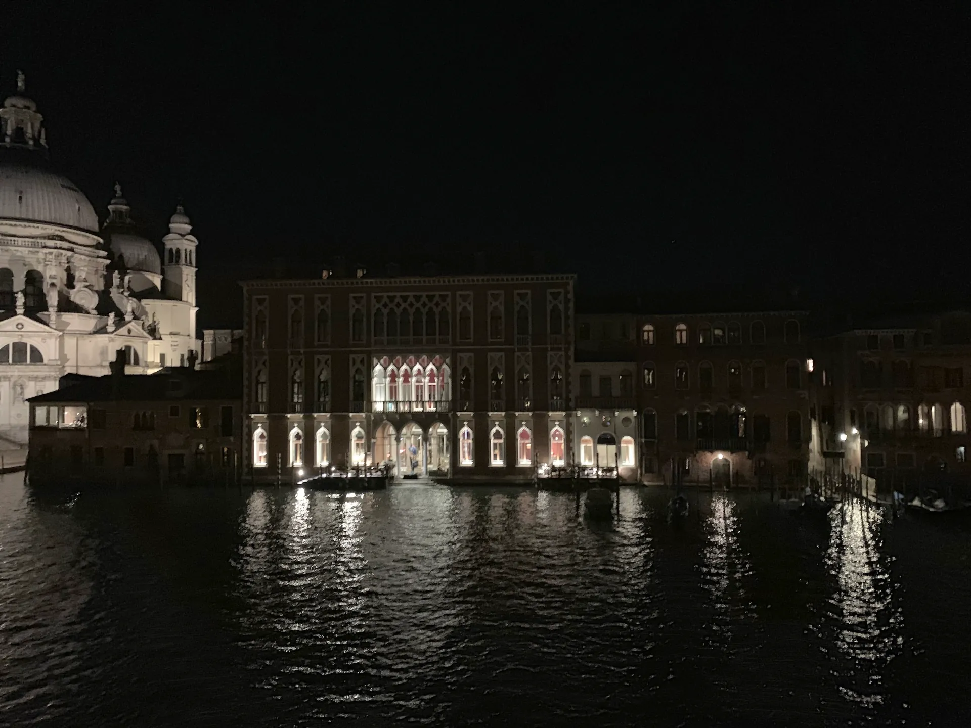 A wide night view of Santa Maria della Salute lit across the water