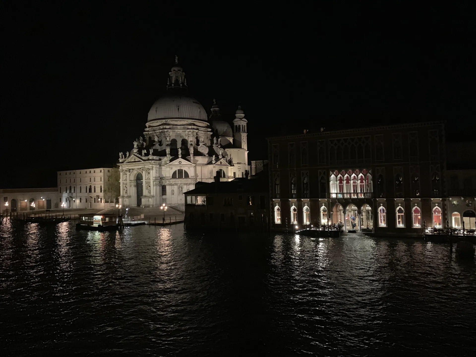 Santa Maria della Salute floodlit at night across the Grand Canal