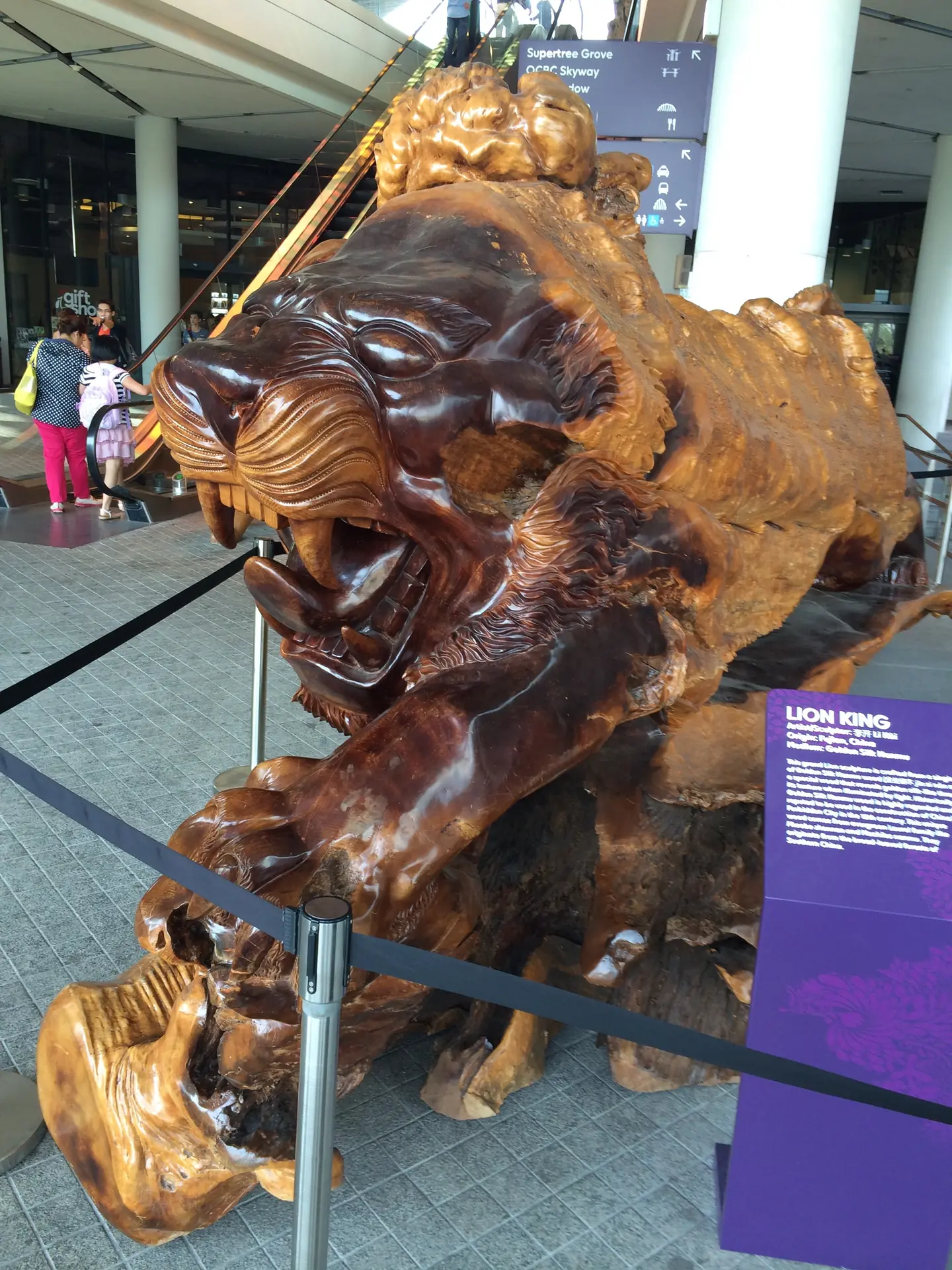 A large carved hardwood lion sculpture on display inside the Marina Bay Sands mall