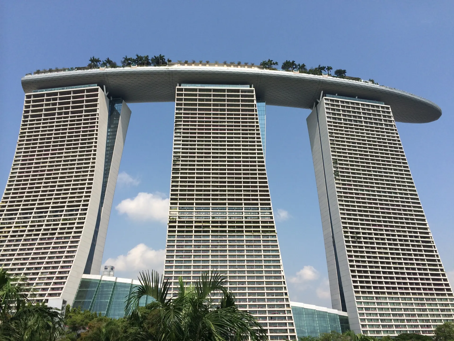 The three towers of Marina Bay Sands rising from the waterfront under a blue sky