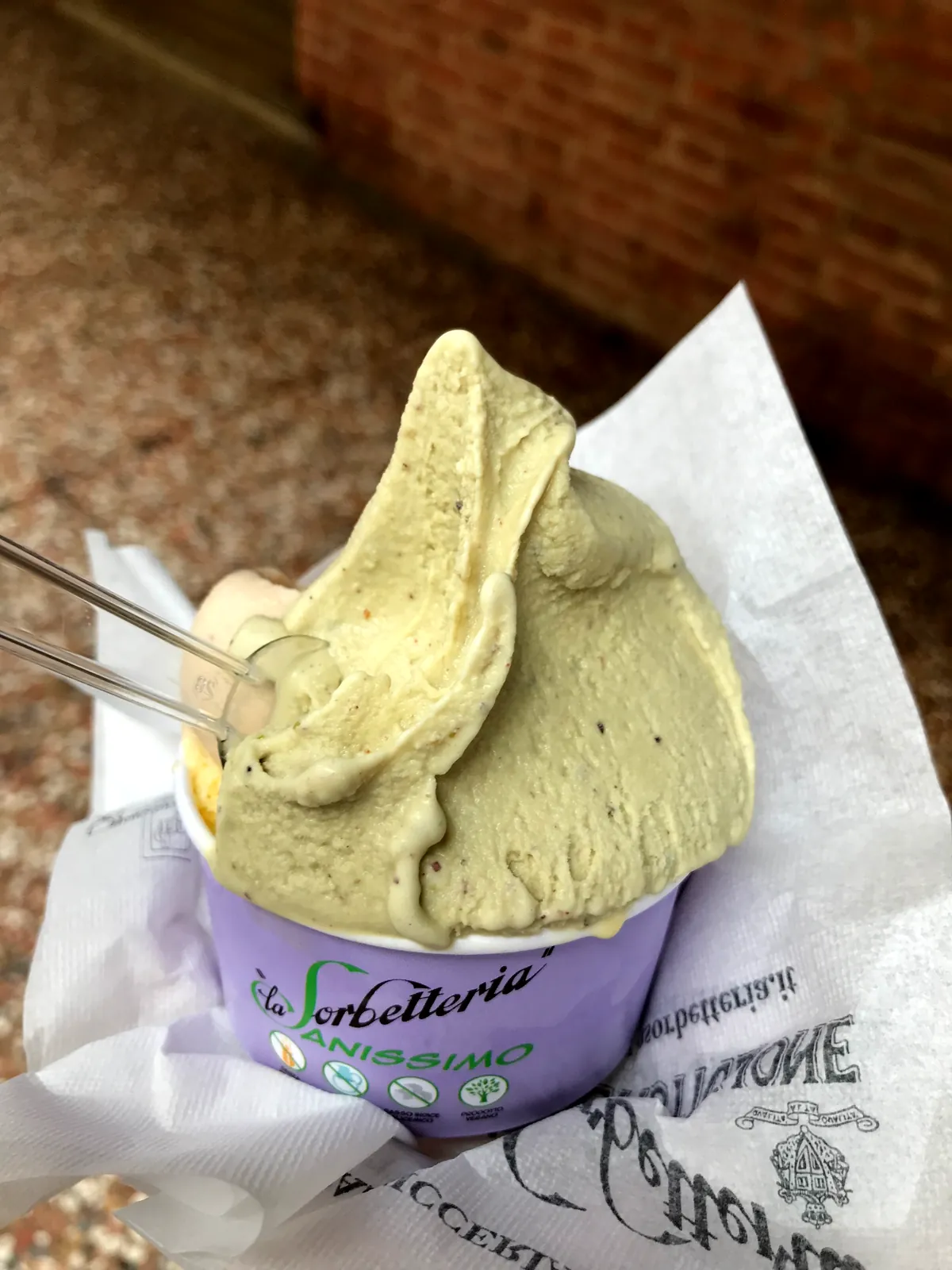 A cup of pale green pistachio and a cream scoop from La Sorbetteria Castiglione.