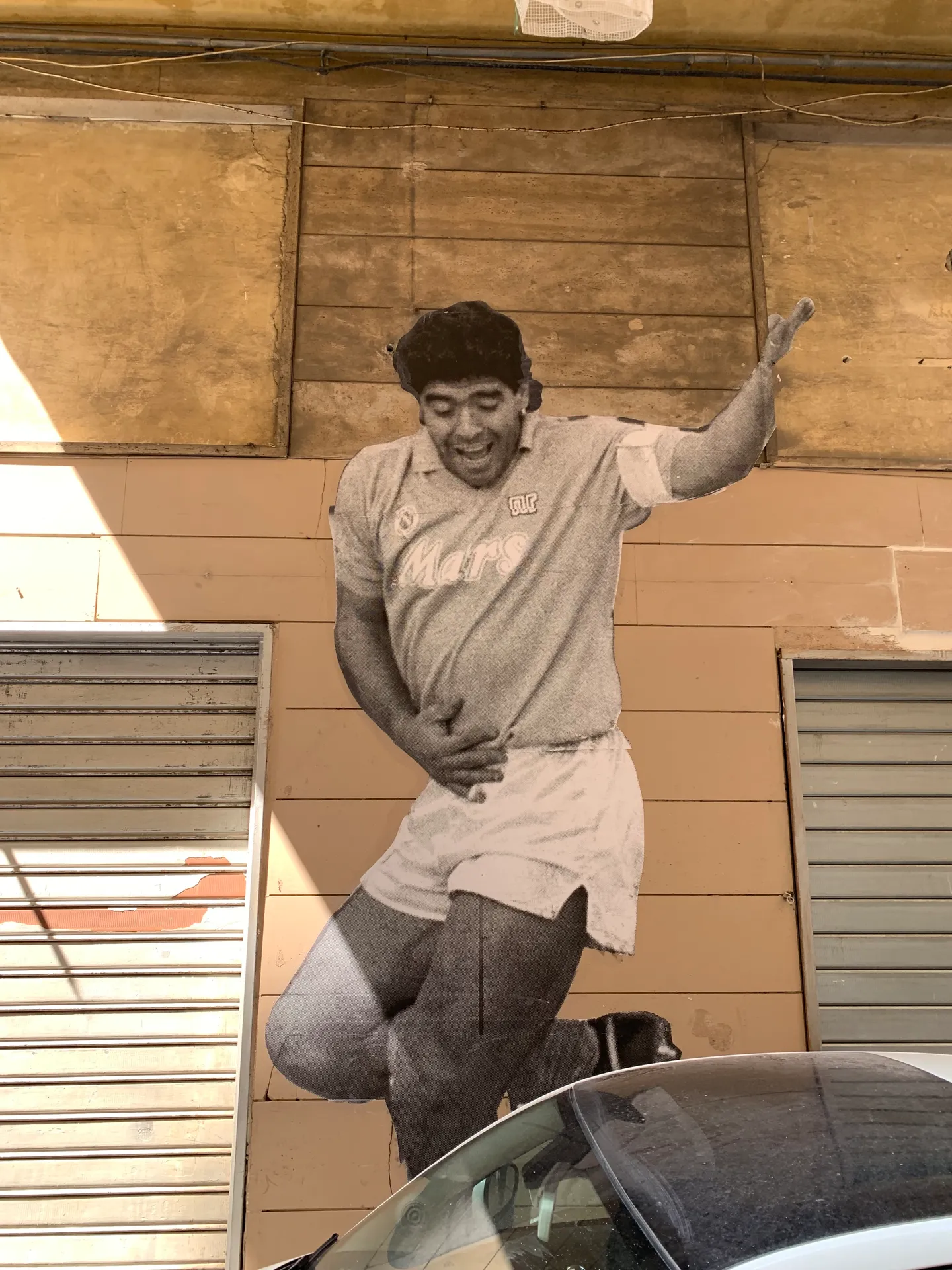 A painted figure of Maradona on a wall in the Spanish Quarter, Naples