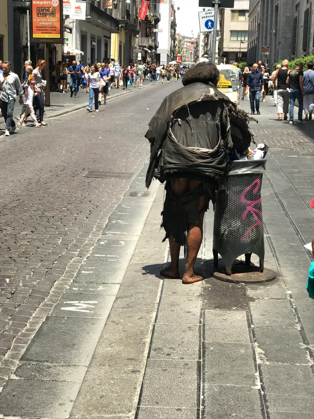 A street sweeper with a bin on Via Toledo in Naples