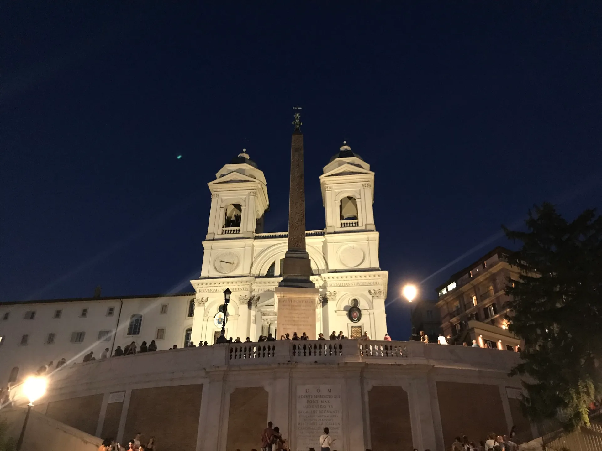 Trinità dei Monti floodlit at night above the Spanish Steps.