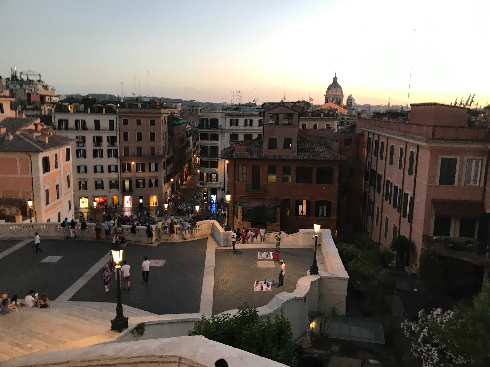 Ochre rooftops of central Rome at twilight from the top of the steps.