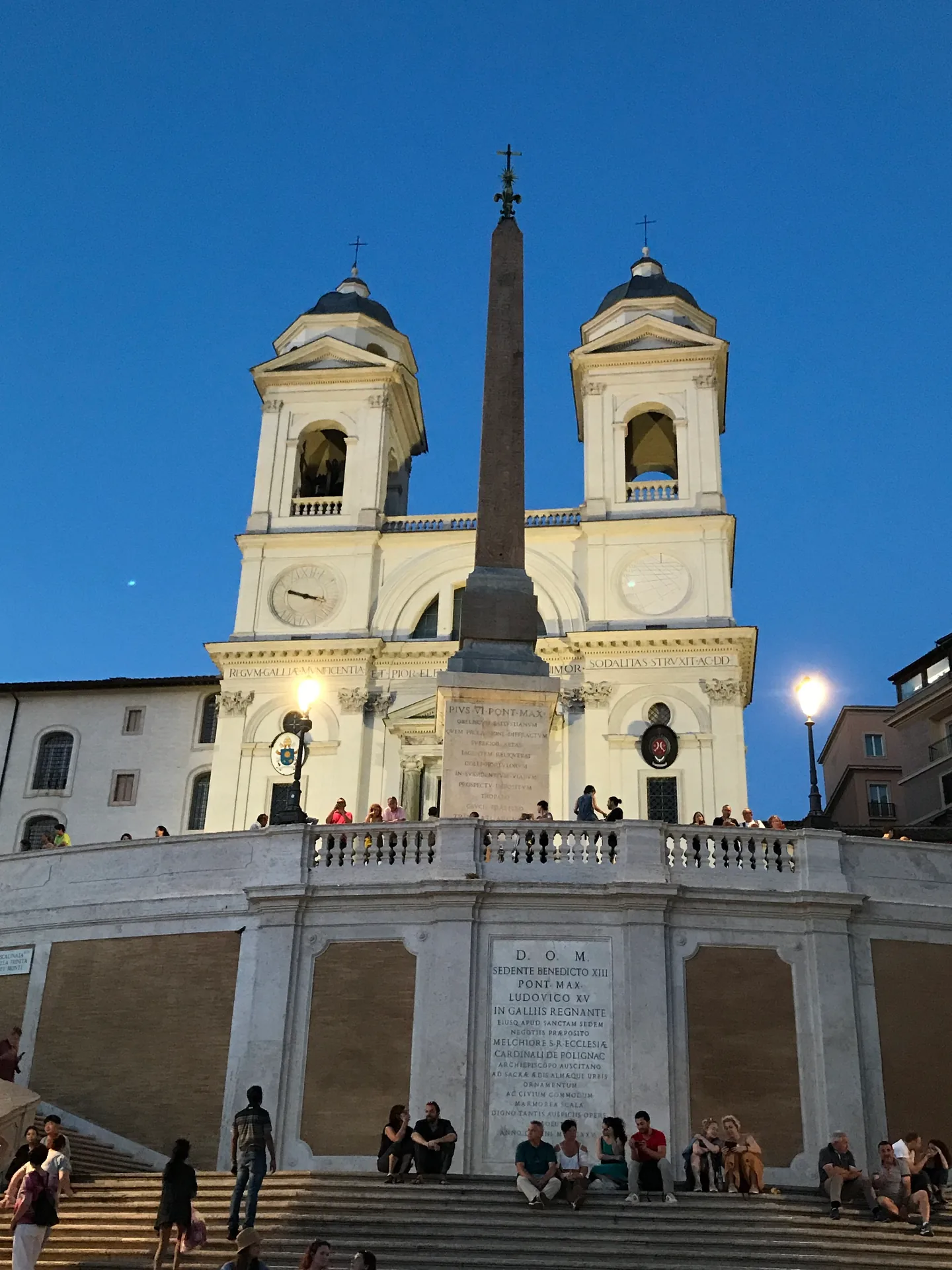 The floodlit twin towers of Trinità dei Monti and the obelisk at blue hour.