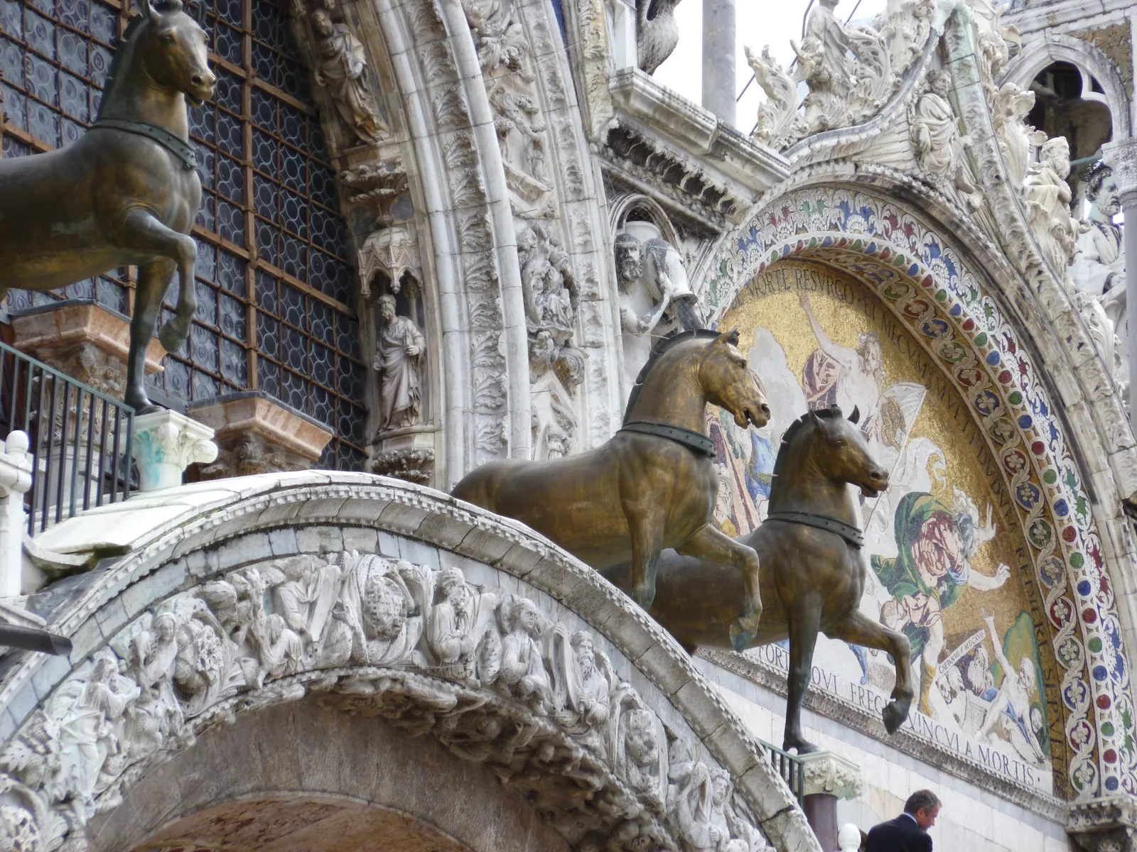 The bronze horses on the loggia of St Mark's with the mosaic arch of the facade behind