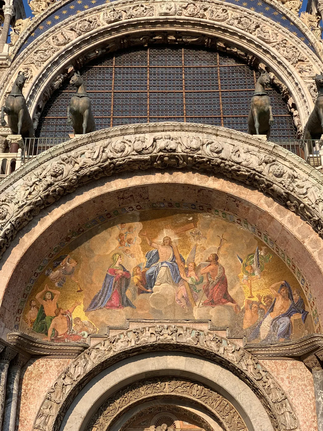 Figural golden mosaic lunette over a doorway of St Mark's Basilica