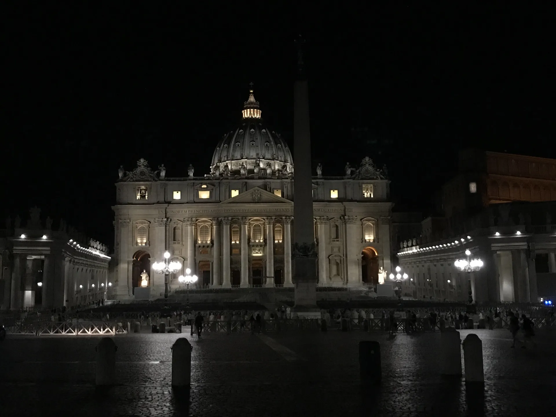 The floodlit facade, dome and obelisk of St. Peter's at night