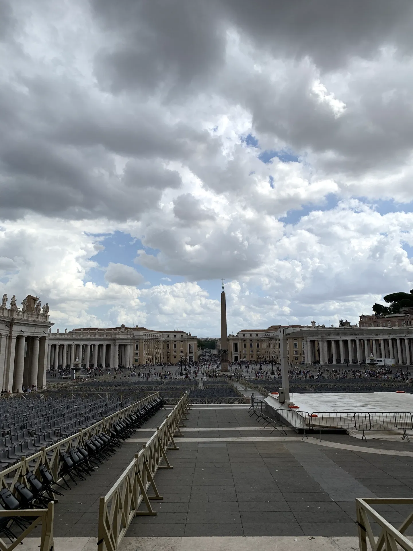 Rows of chairs set out in St. Peter's Square before the obelisk and facade