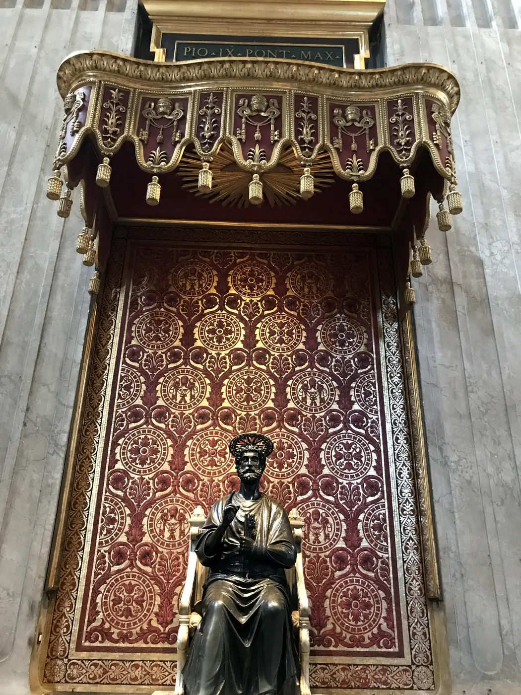 The medieval bronze statue of St. Peter enthroned, its foot worn smooth