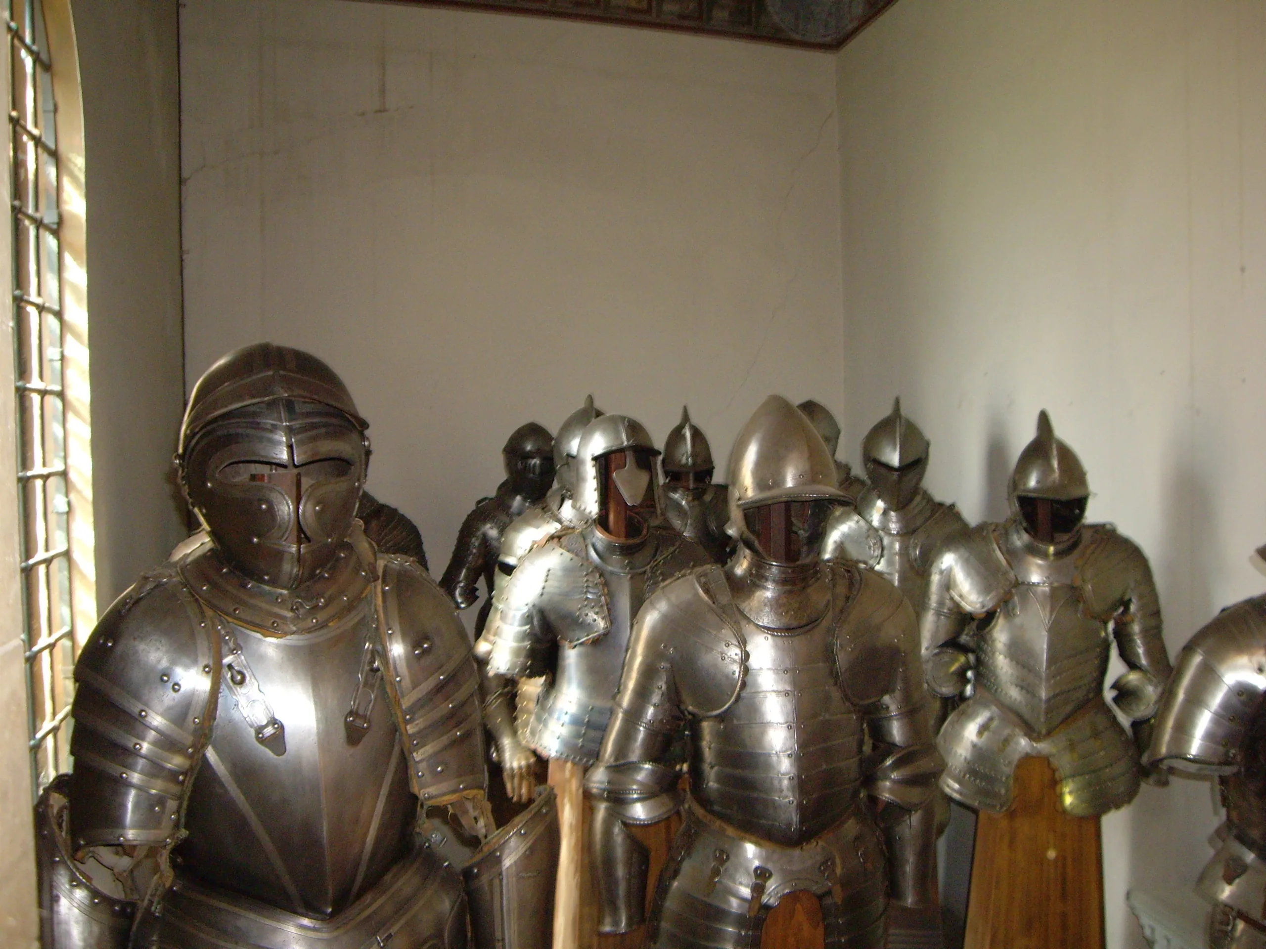 A rank of sixteenth-century plate armours standing in one of the Stibbert armoury rooms