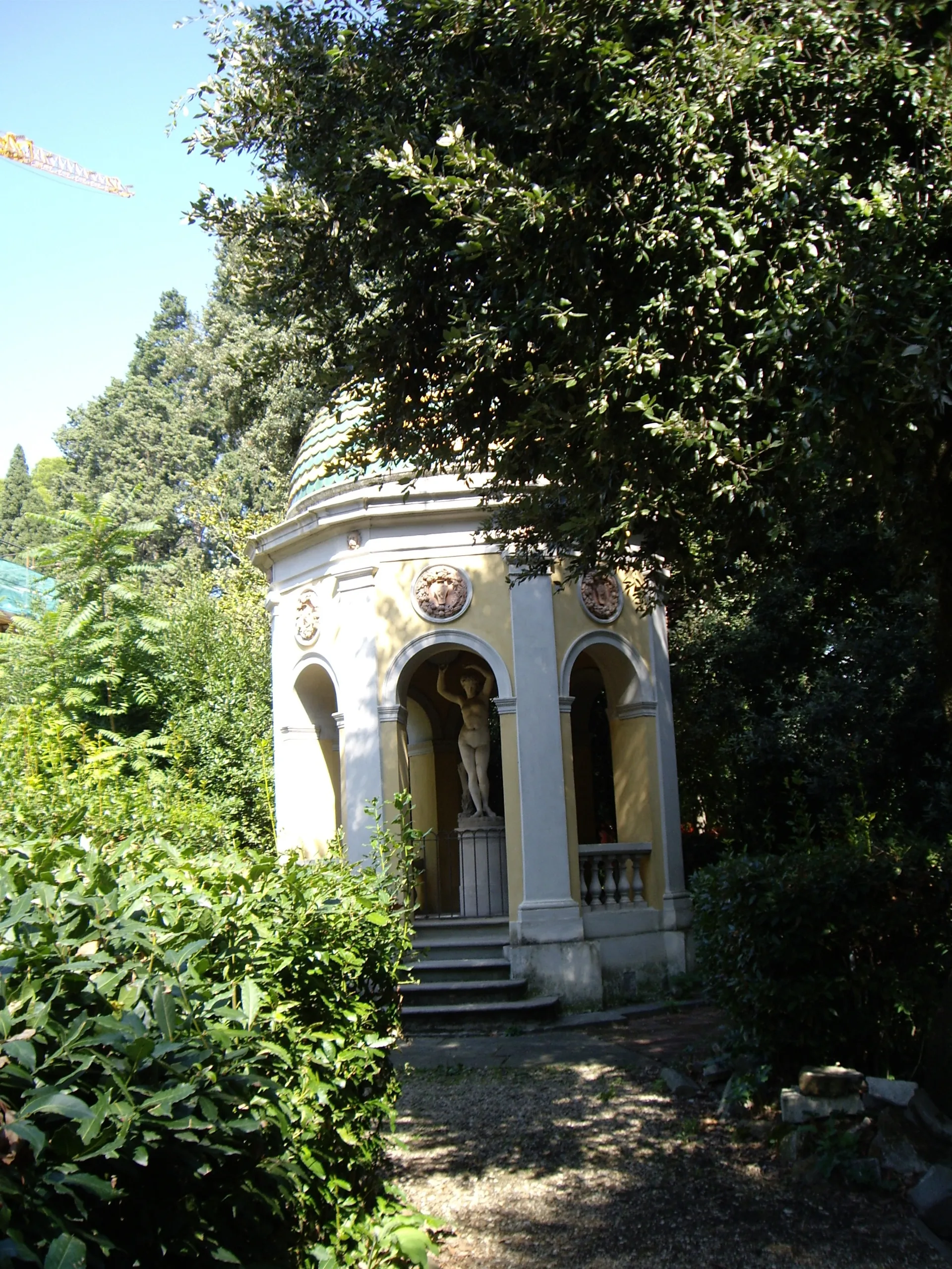 A small domed temple standing among the trees of the Stibbert park