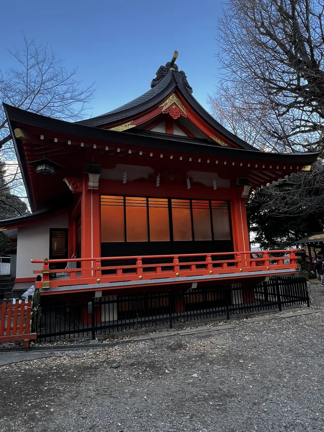 Wooden Shinto shrine hall glowing at dusk in Tokyo