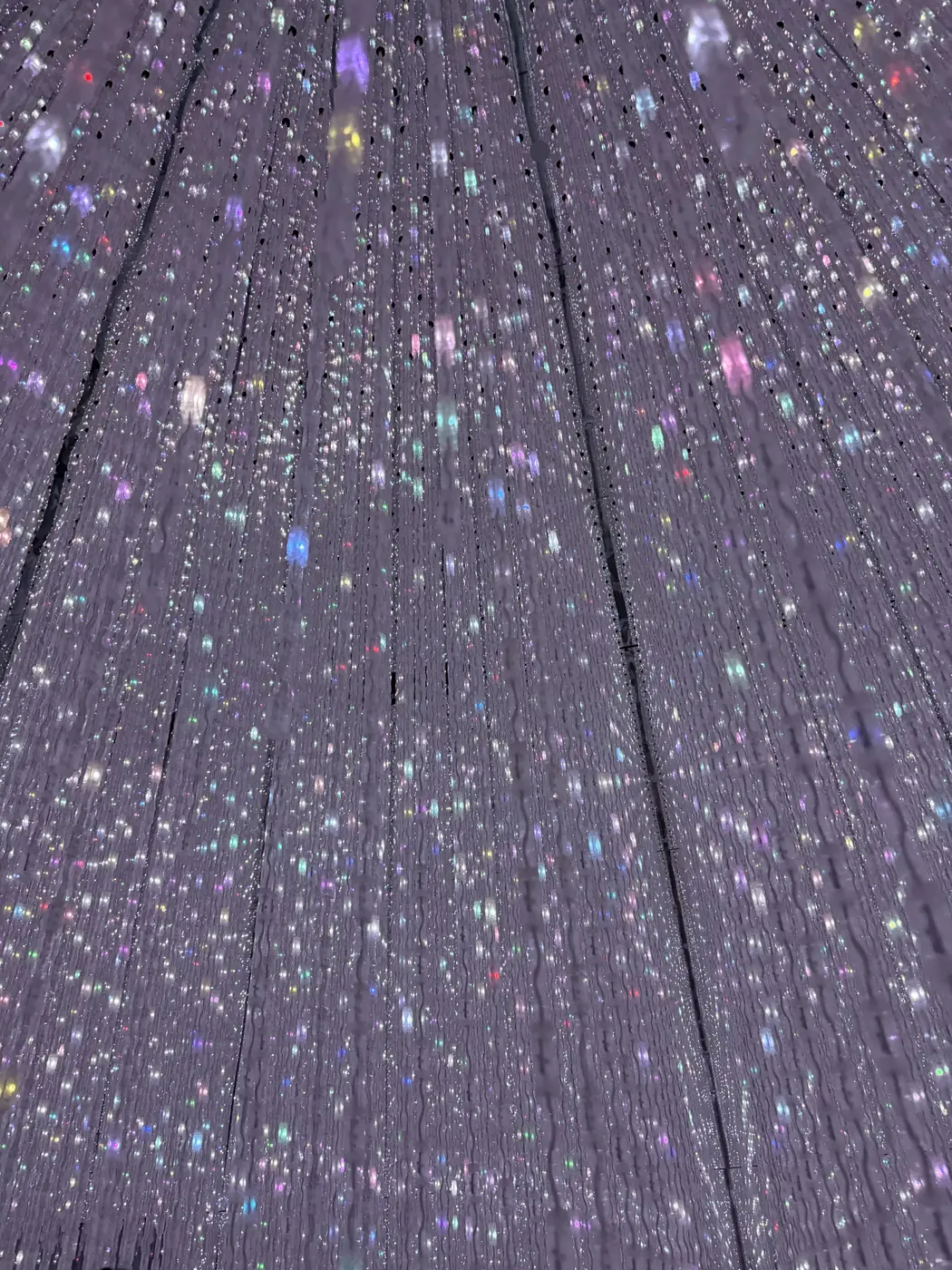 Strands of falling light like glittering rain in a teamLab installation, Tokyo