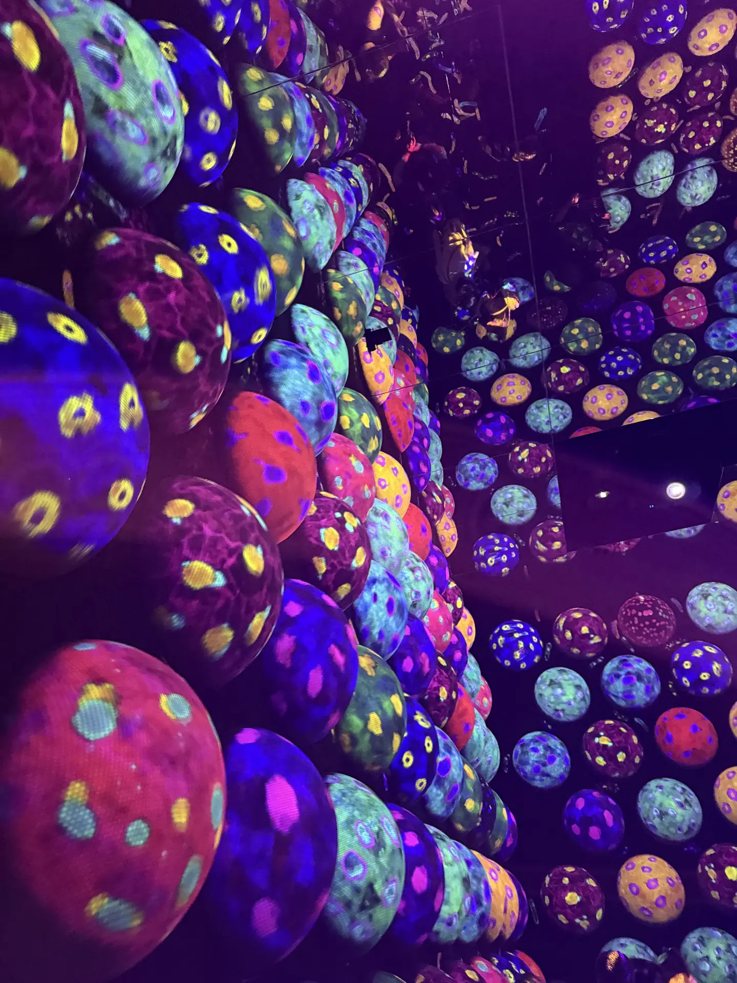 Colorful patterned light spheres in a teamLab installation, Tokyo