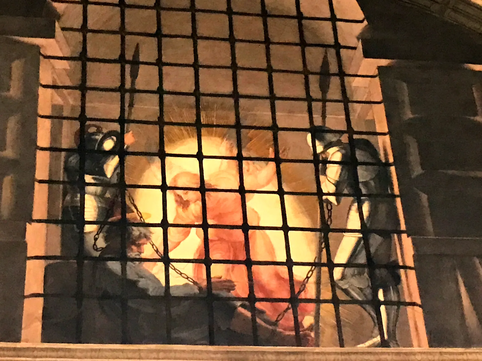 Raphael's night fresco the Liberation of Saint Peter around a barred prison window.