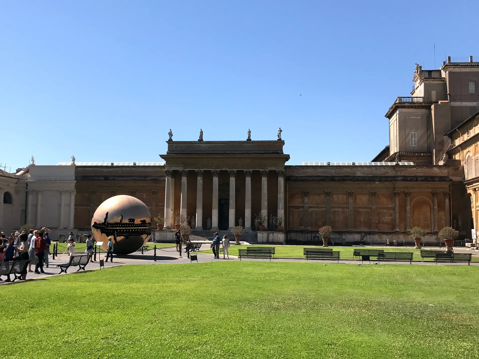 The Cortile della Pigna at the Vatican Museums with Pomodoro's bronze sphere on the lawn.