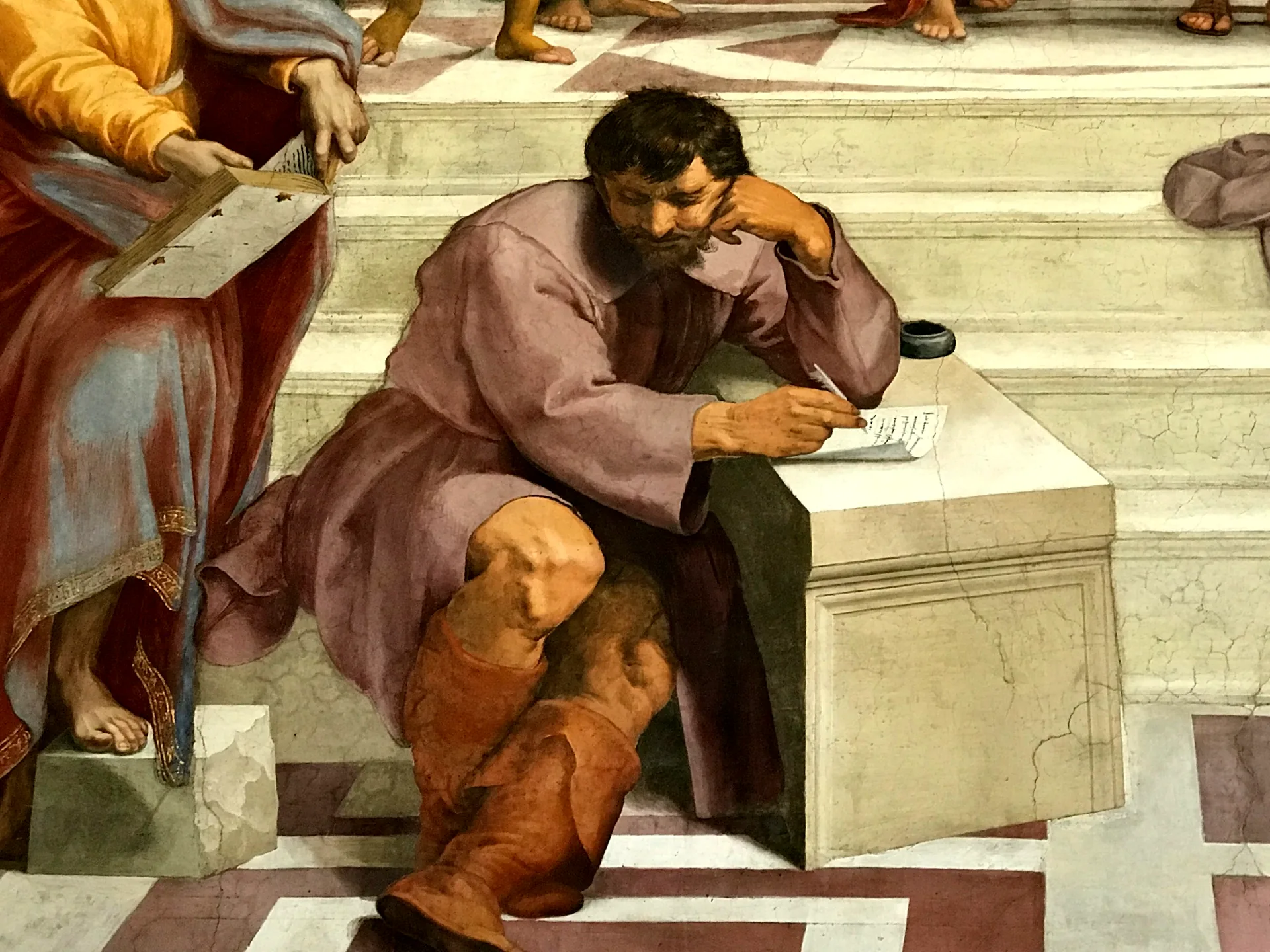 Detail of Raphael's School of Athens showing the lone brooding figure on the steps.
