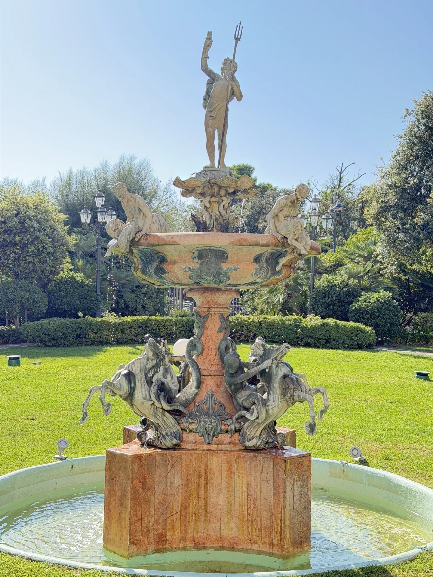 The garden fountain of the Grand Hotel Rimini, a trident-bearing figure above rearing sea horses