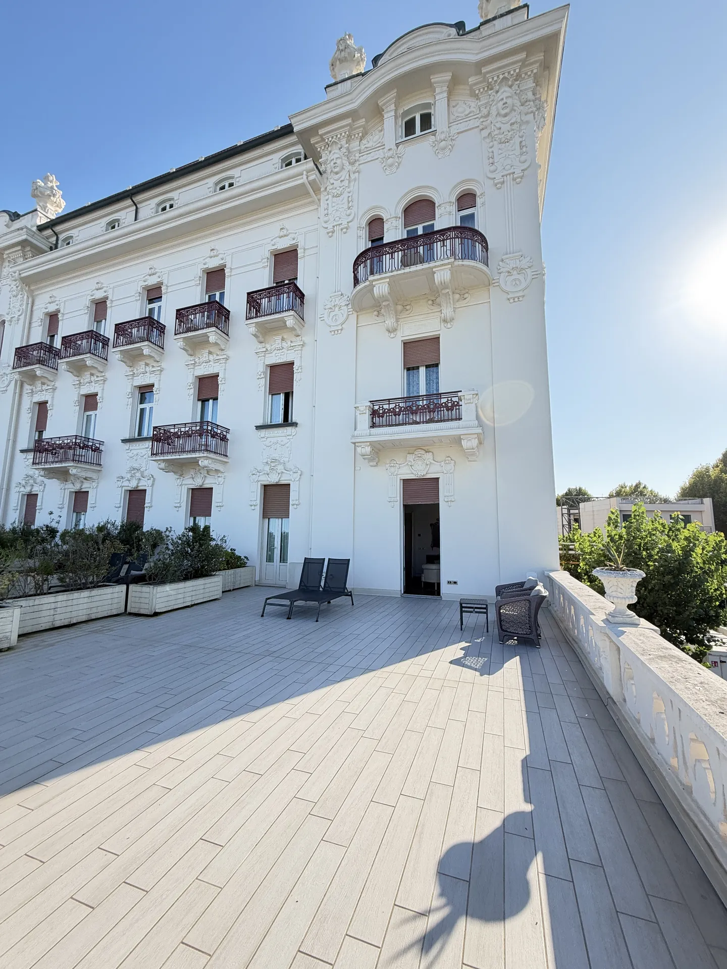 The Liberty wing and corner tower of the Grand Hotel Rimini seen from a room terrace