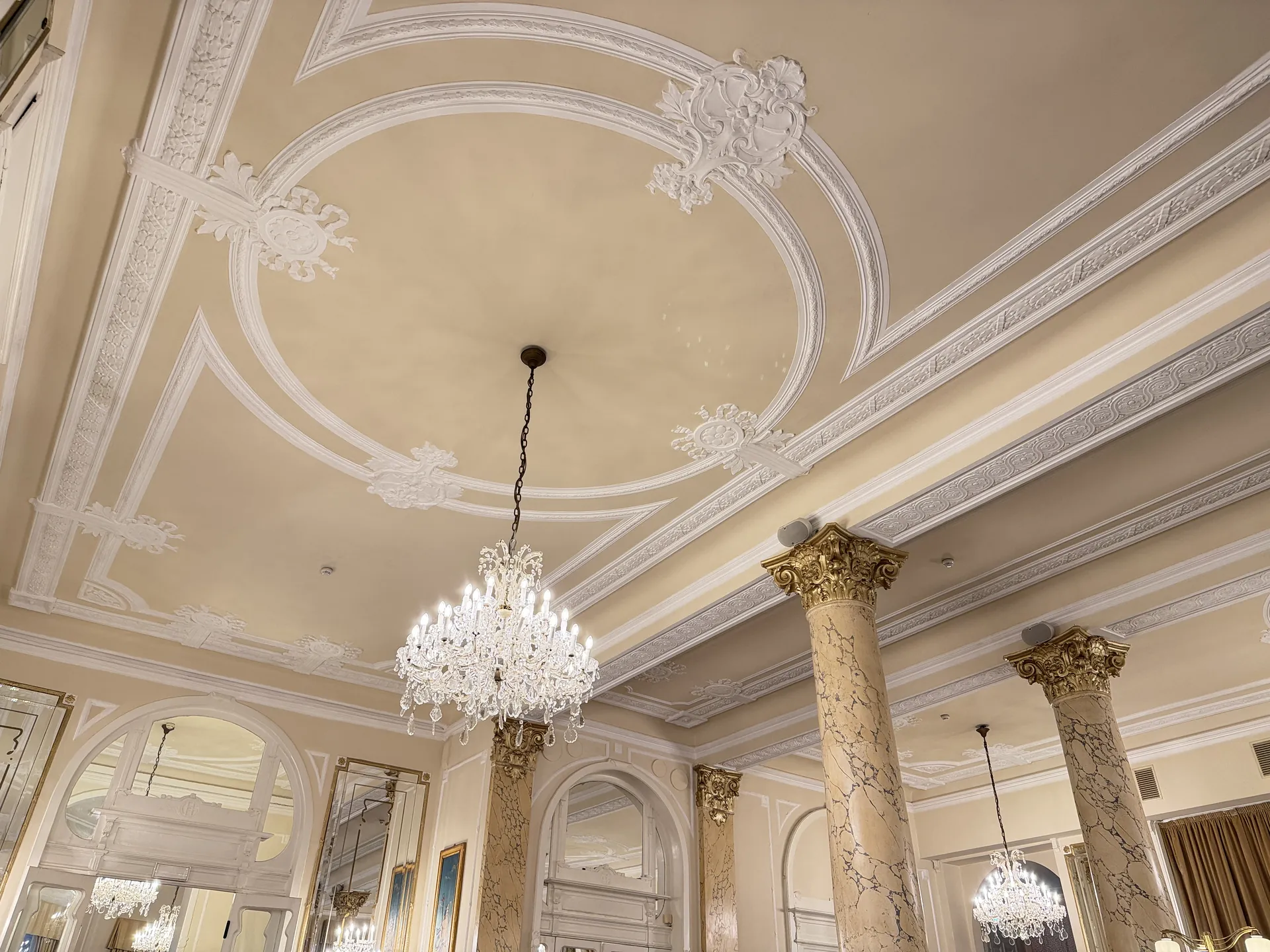 Chandeliers and moulded plasterwork on the ceiling of the hotel dining room