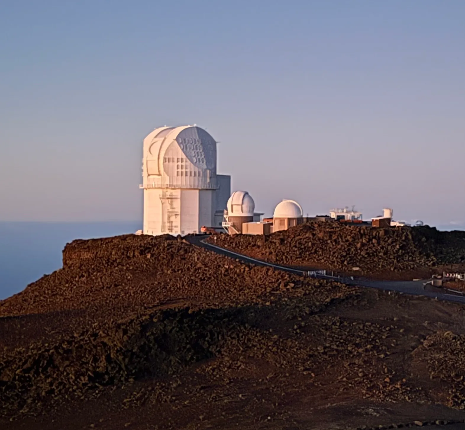 The faceted white dome of the Inouye Solar Telescope on the Haleakala summit ridge