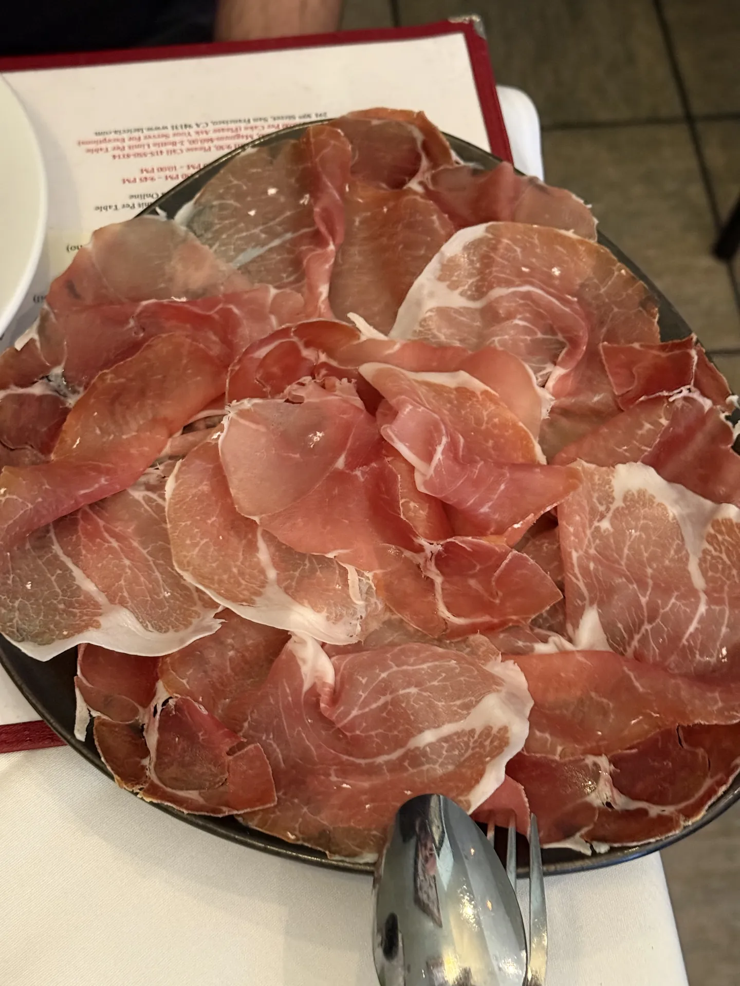 A platter of thinly sliced prosciutto aged 24 months.
