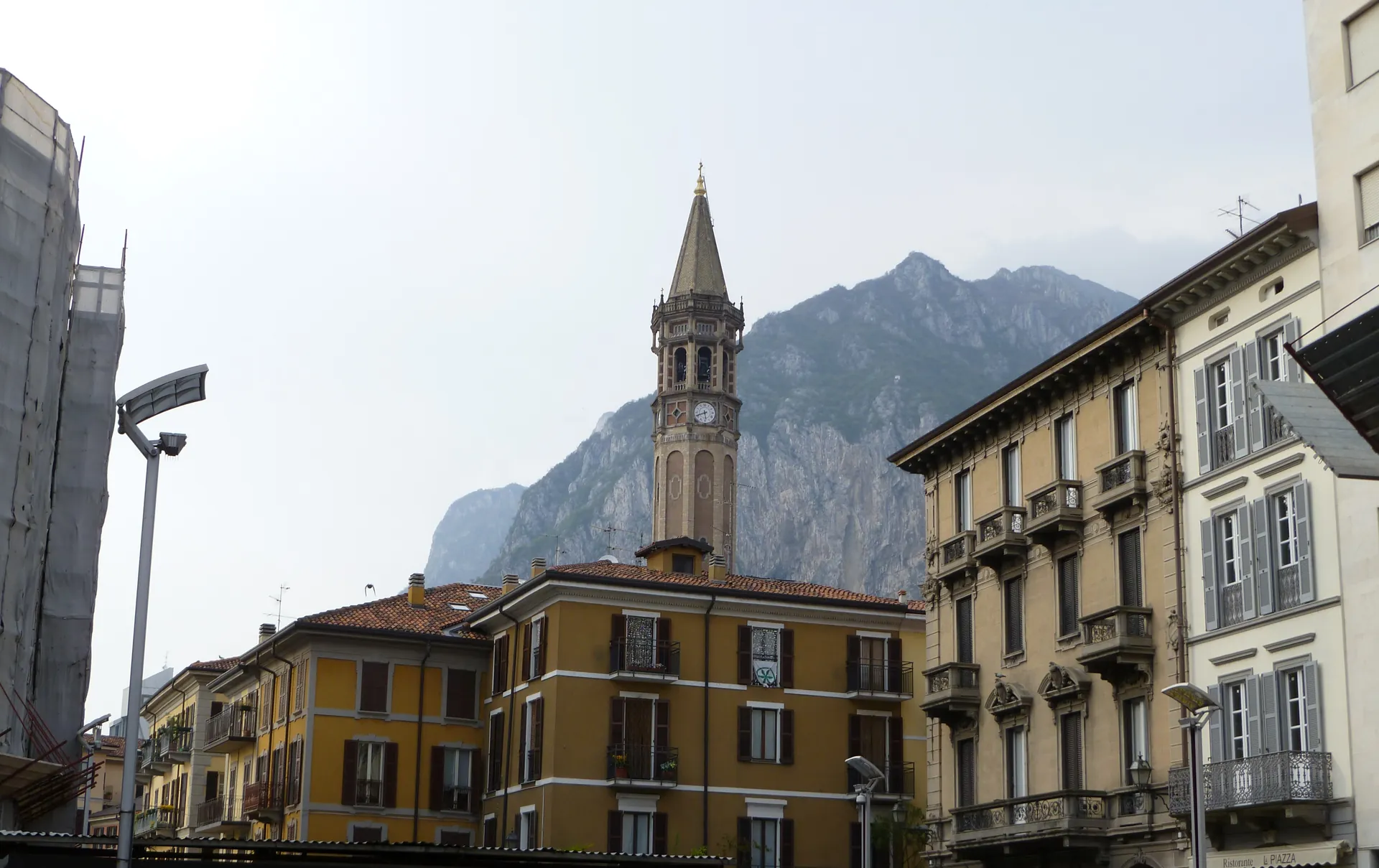 The tall octagonal campanile of the Basilica di San Nicolo above the rooftops of Lecco.