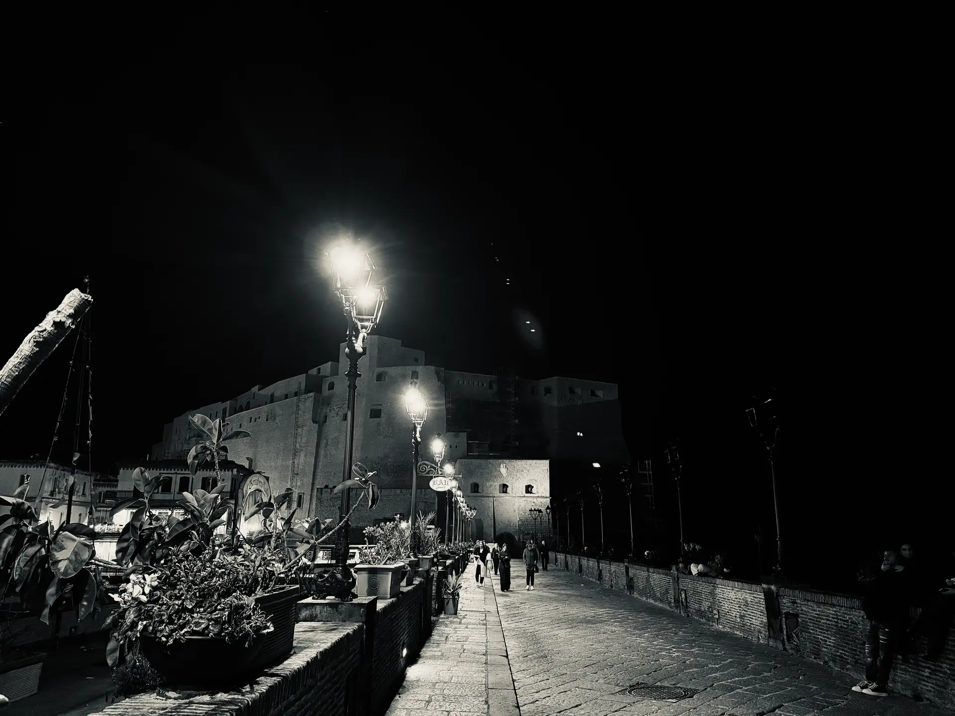 The lamp lit causeway to Borgo Marinari in Naples close to midnight in December.
