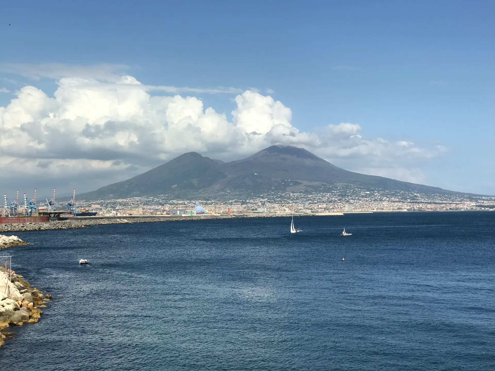 Mount Vesuvius seen across the Bay of Naples from the Lungomare breakwater.