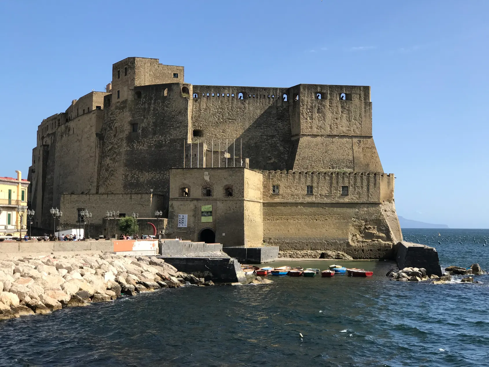 The walls of Castel dell'Ovo rising directly out of the sea in Naples.