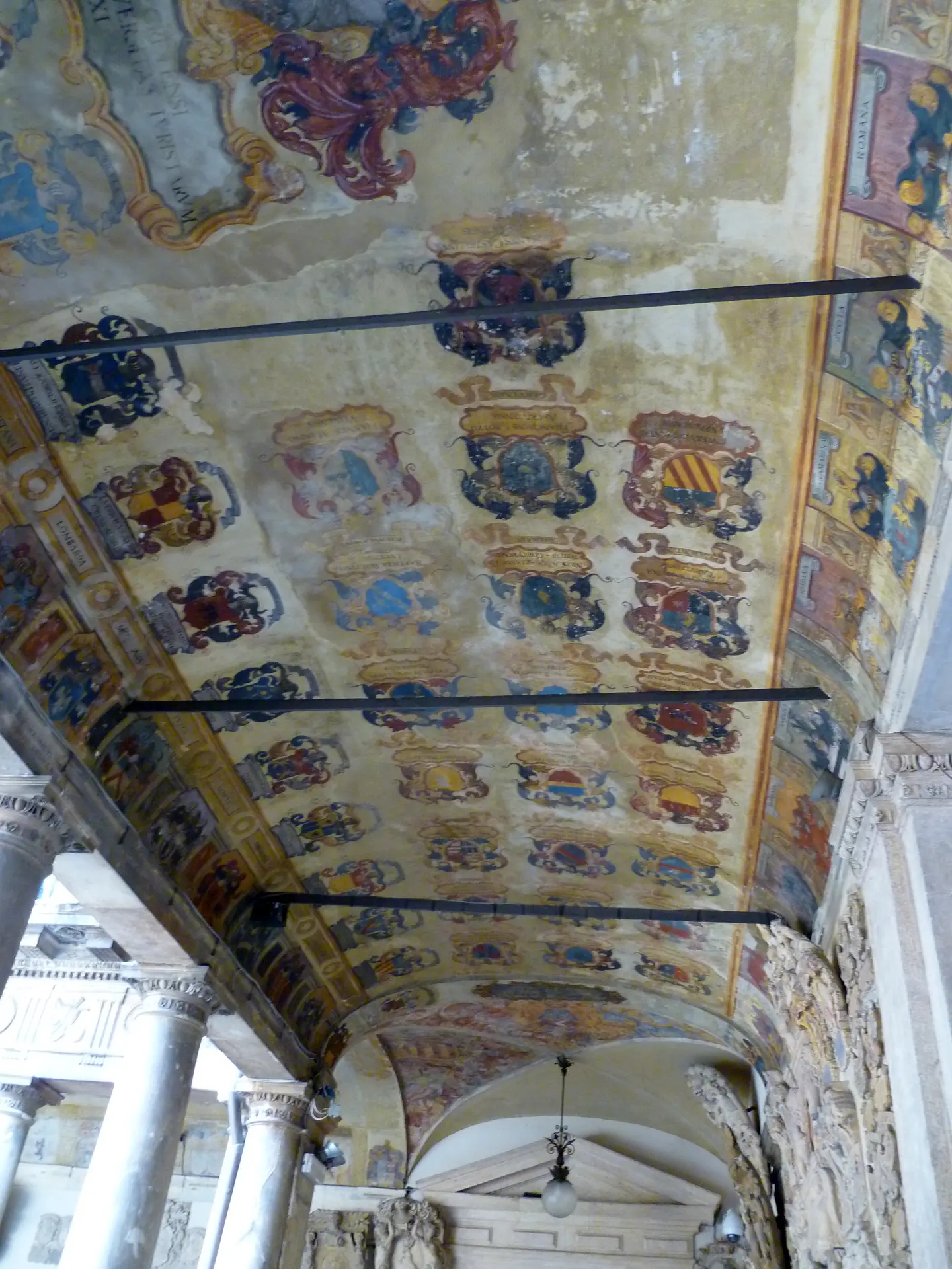 The painted vault of the courtyard loggia at Palazzo del Bo, covered in heraldic shields