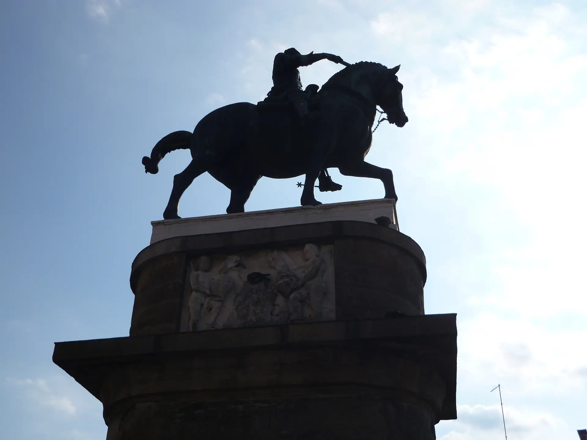 Donatello's bronze equestrian monument to the Gattamelata in Padua, silhouetted against the sky