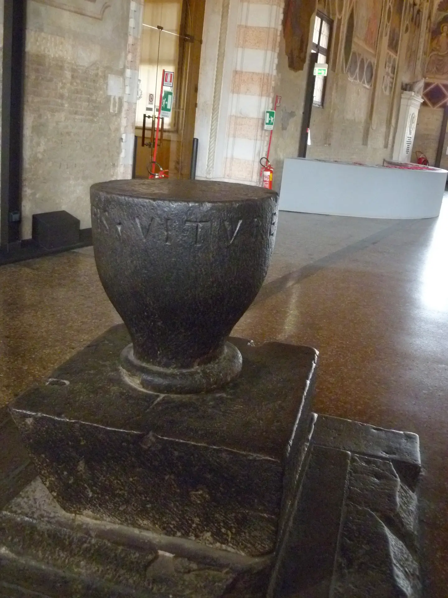 The Pietra del Vituperio, a black stone block on a plinth inside the Salone in Padua