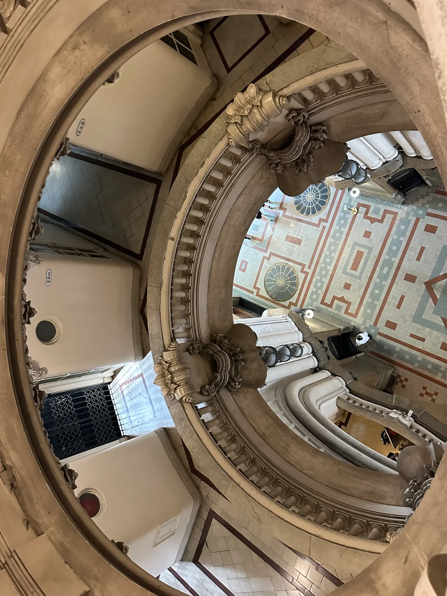 Looking up a tall interior light well at Palacio Barolo toward the dome.