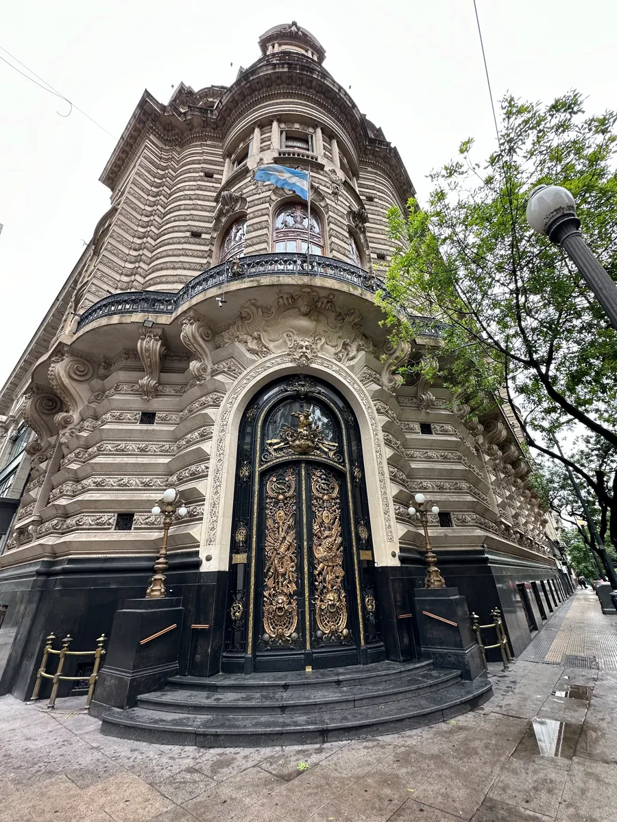 Palacio Barolo seen from its own doorway, the tower rising the full height of the frame.