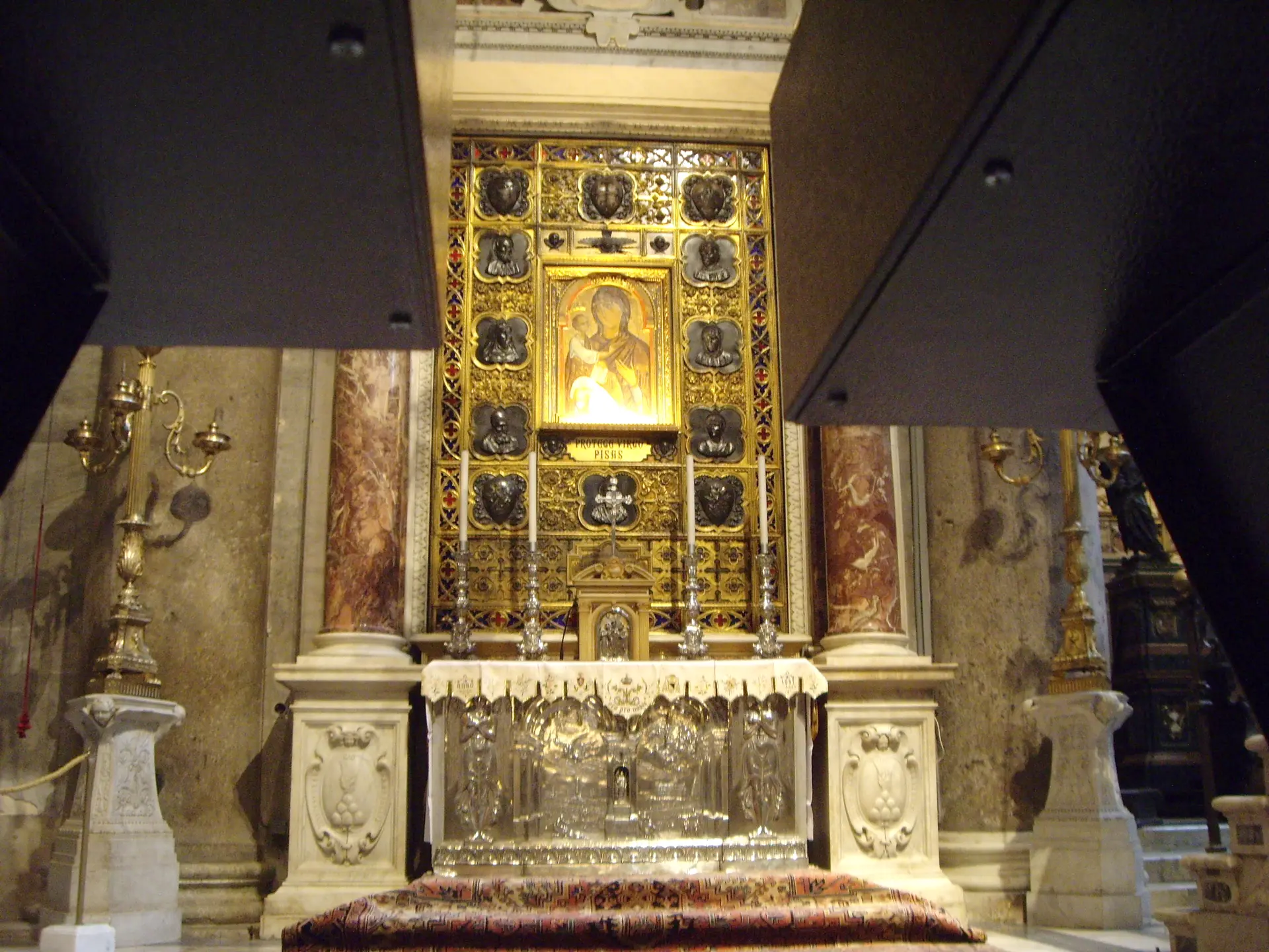 A gilded side altar with a silver frontal in Pisa cathedral