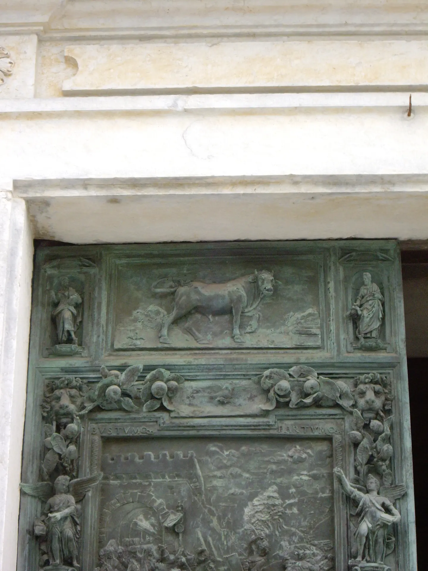 A bronze door of Pisa cathedral, its panels cast with figures and animals