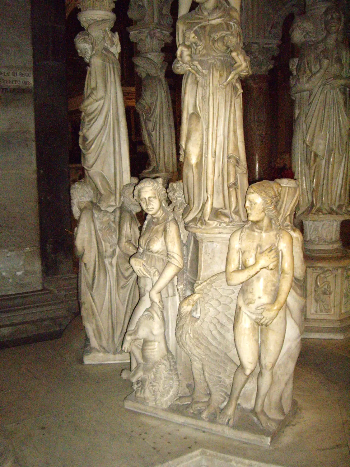 Carved figures supporting the base of Giovanni Pisano's pulpit in Pisa cathedral