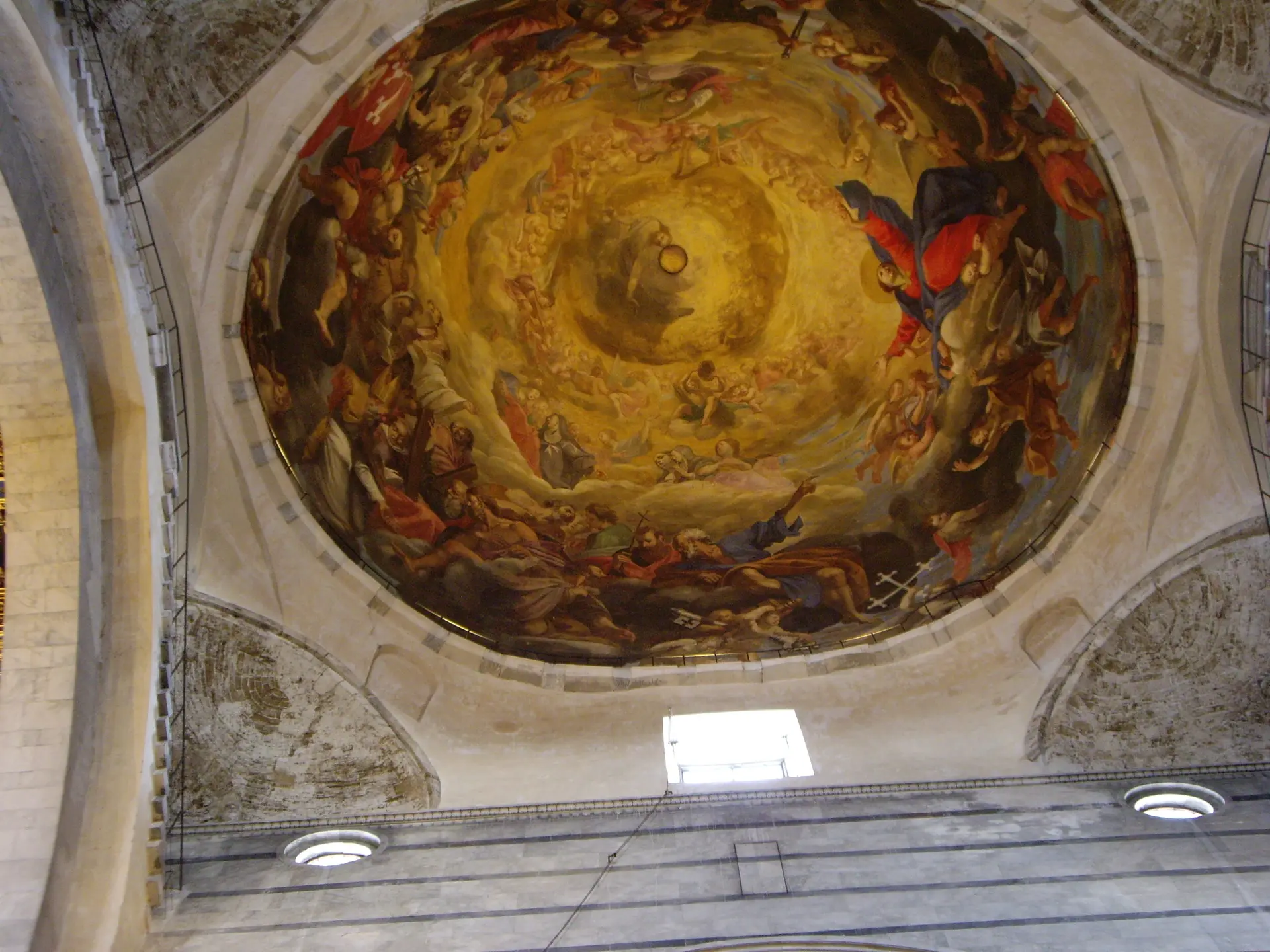 The painted cupola of Pisa cathedral, a gilded swirl of figures overhead