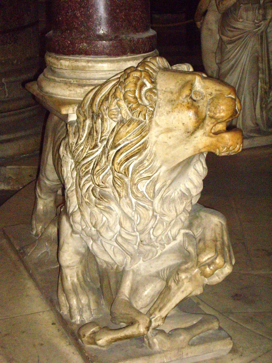 A marble lion crouching at the base of Giovanni Pisano's pulpit in Pisa cathedral