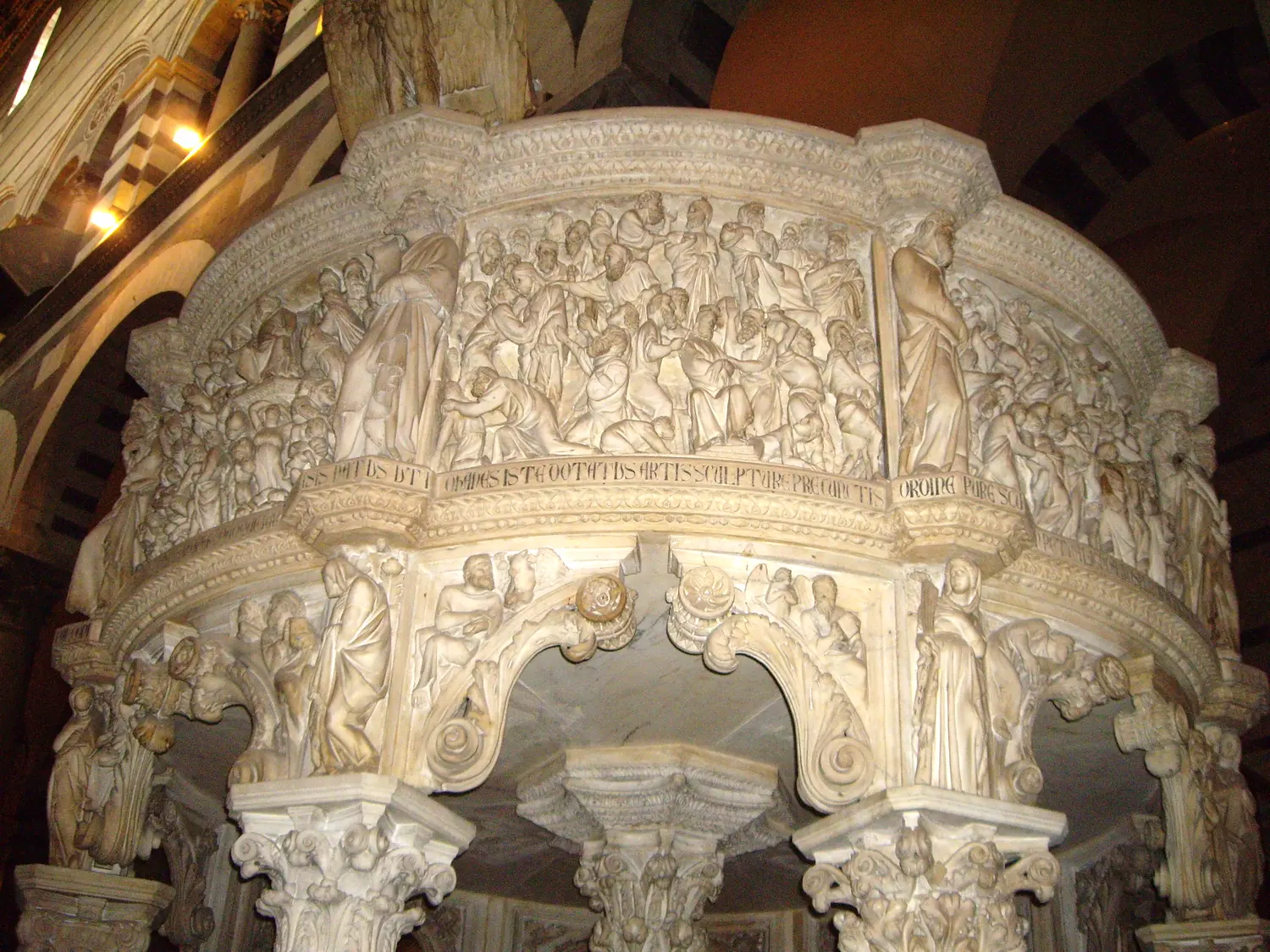 Giovanni Pisano's carved marble pulpit in Pisa cathedral, crowded with figures