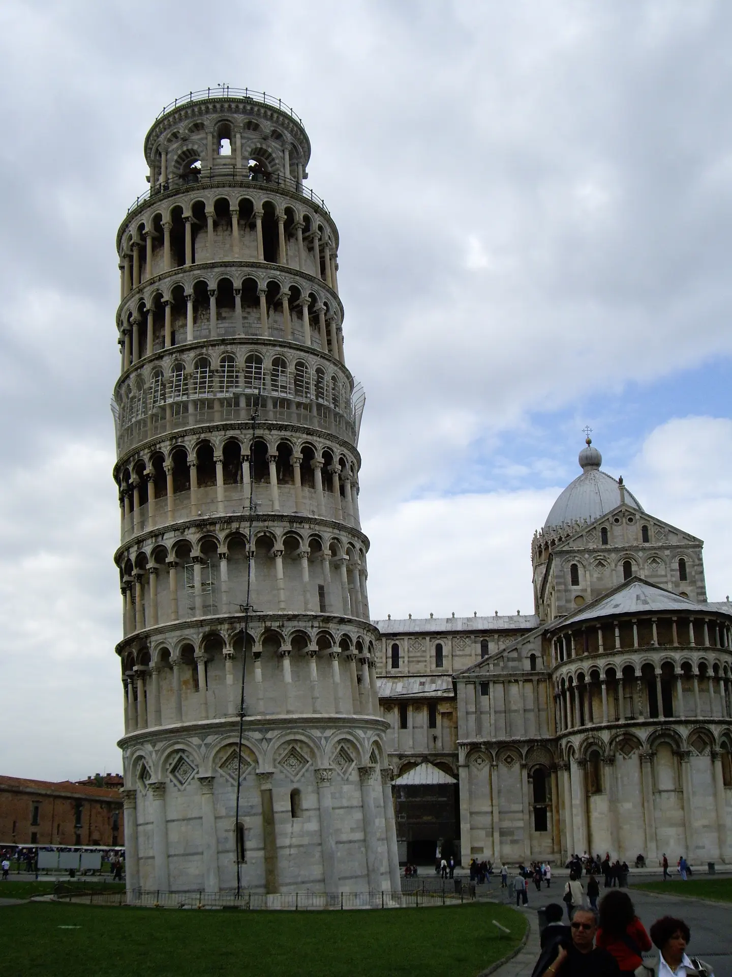 The leaning tower of Pisa standing full height beside the cathedral apse