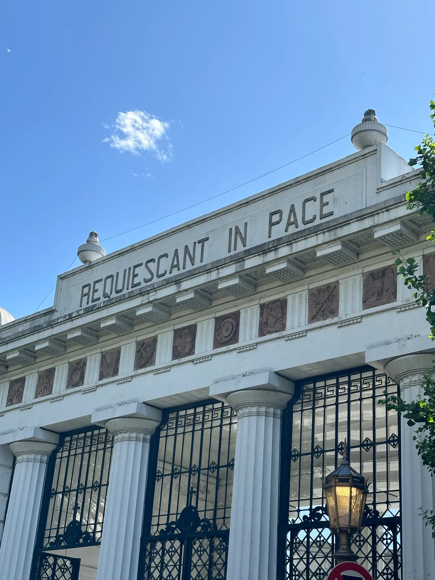 The words REQUIESCANT IN PACE in raised letters on the Recoleta Cemetery wall.