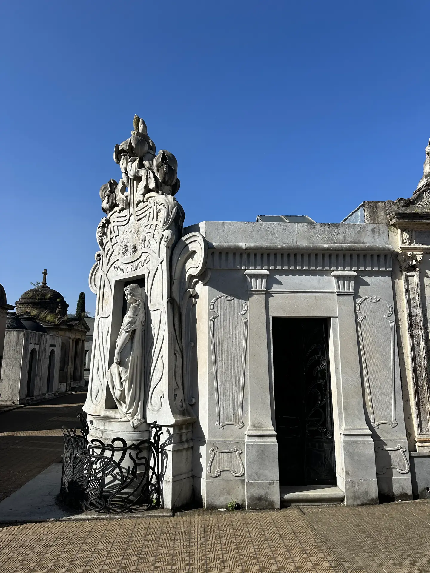 The art nouveau tomb of Rufina Cambaceres, a marble girl with her hand on the door.